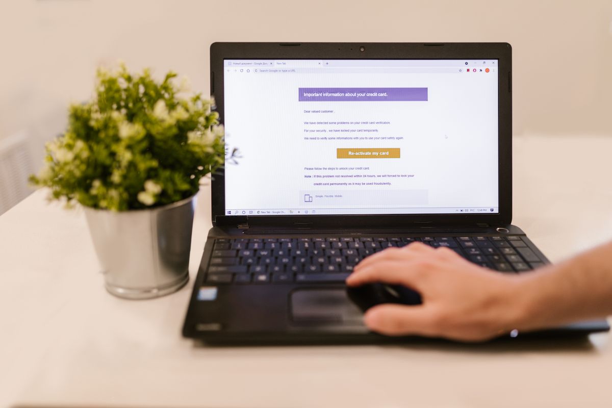 Hand on a laptop with an email open
