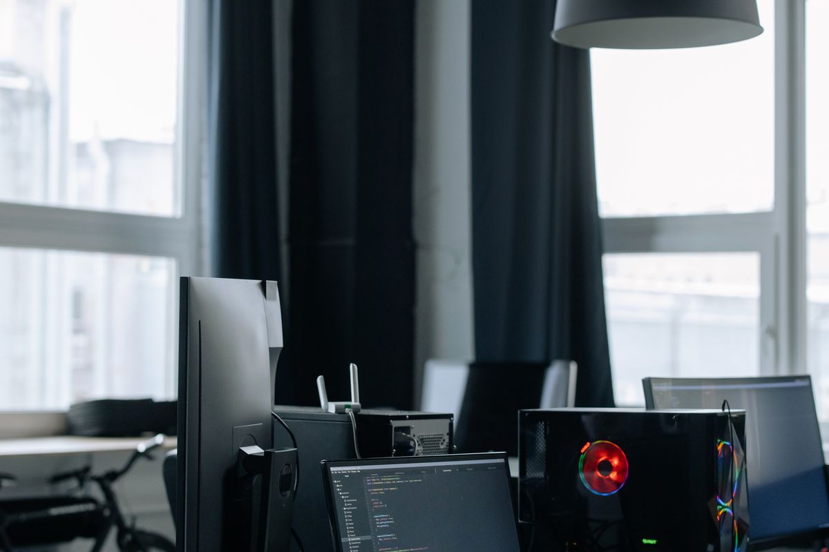 Office desk with computers and monitors
